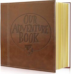 a brown leather book with the words our adventure book on it