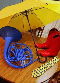 a yellow umbrella and some musical instruments on a table with a quote about watching the finale, i can't look at how you met your mother the same way anymore