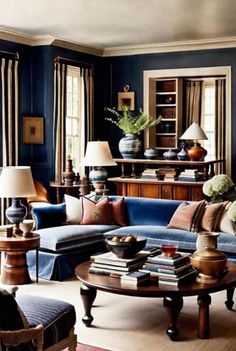 a living room filled with blue couches and lamps on top of tables in front of windows