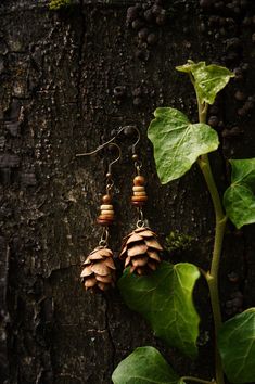 Nature jewelry lovers watch out! The forest jewelry collection is expanded with new pine cone earrings. These beautiful wooden earrings are studded with real pine cones, collected in the Black Forest in southern Germany, and will delight any hippie or boho lover. The handmade wooden jewelry pieces are a perfect gift for the nature jewelry lover. Each earring has been carefully crafted from natural materials, making them one-of-a-kind. Wear a piece of the forest on your ears with a pair of fir earrings and show your love for nature. These ethnic earrings are versatile enough to be worn with a variety of outfits. Explore our collection of fir earrings and wooden jewelry and find the piece of jewelry that enhances your personality. Treat yourself or a loved one to something special that is gu Pine Cone Jewelry Diy, Pine Needle Earrings, Pine Cone Earrings, Pine Cone Jewelry, Handmade Wooden Jewelry, Forest Earrings, Forest Jewelry, Needle Earrings, Southern Germany