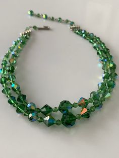 "This green glass beaded necklace from the 1960s is gorgeous and perfect for any vintage jewelry lovers collection! Beautiful shine with the color changing iridescence of the Aurora borealis beads. This necklace is about 16\" with the second stand slightly longer and has a hook clap that works perfectly. Please don't hesitate to reach out with any questions - I absolutely LOVE this piece! Thanks for looking!" Cheap Green Double Strand Beaded Necklace, Vintage Green Double Strand Necklaces, Vintage Green Double Strand Necklace, Green Double Strand Beaded Necklace, Green Czech Glass Necklaces For Party, Vintage Green Faceted Beads, Green Double Strand Necklace With Faceted Beads, Vintage Green Multi-strand Necklace, Vintage Green Multi-strand Beaded Necklaces