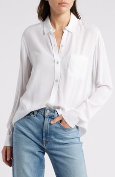 Expand your wardrobe options significantly with this flowy and versatile white button-up shirt. 27" length (size Medium) Front button closure Spread collar Long sleeves with button cuffs Chest patch pocket 100% rayon Hand wash, line dry Imported Classic White Blouse With Roll-up Sleeves, Effortless White Button-up Blouse, Daywear Button-up Rayon Shirt, Classic Relaxed Fit Rayon Blouse, Classic White Blouse With Rolled Sleeves, Classic Blouse With Relaxed Fit, White Blouse With Buttoned Pockets For Spring, Classic Rayon Blouse With Relaxed Fit, White Button-up Blouse With Rolled Sleeves