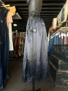 Antique Silk Charcoal Black Full Length Skirt. Charcoal gray/black in color. Brand is unknown. Skirt is made from silk fabric. Full length skirt with a flowy fit. Side hook and eye closure with snaps down the side. Super soft with a lightweight feel. Oversized button accents on sides. Condition overall is good/fair with some flaws that include; there are pinholes along front and couple on back of skirt. Small tear at bottom hem. Please see all photos for details.  Refer to measurements below to ensure a proper fit (modeled on a size small mannequin) fits true to size 12.5" across waist (25") 37" in total length Black Silk Flared Skirt, Evening Full Skirt With Elastic Waistband, Evening Full Skirt Bottoms With Elastic Waistband, Vintage Silk Long Skirt, Silk Gathered Skirt, Silk Full Skirt With Gathered Detail, Black Silk Pleated Skirt Bottoms, Black Silk Bottoms With Pleated Skirt, Silk Lined Long Skirt