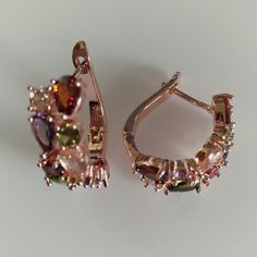 Multicolored Rhinestone Earrings In Rose Gold Tone. Convenient Flip Back Clips Prevent Earrings From Falling Off. Elegant And Lovely. Elegant Multicolor Hoop Earrings For Party, Elegant Multicolor Earrings With Sparkling Stones, Elegant Multicolor Cubic Zirconia Crystal Earrings, Elegant Jeweled Hoop Earrings Gift, Elegant Multicolor Gemstone Hoop Earrings, Multicolor Cubic Zirconia Crystal Earrings, Party Rose Gold Gemstone Earrings, Rhinestone Earrings, Red Gold