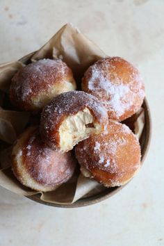 powdered sugar covered doughnuts in a bowl