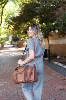 Equal parts stylish and spacious, our vegan leather Peek-A-Boo Diaper Bag Satchel is made for moms who do it all—just like the bag itself. And don't be fooled by this beauty. While the satchel diaper bag is purposely designed to look and feel more like a fashion bag, it has all the features and functions of a true diaper bag hidden inside, including plenty of pockets. You can carry the Satchel with the vegan leather top handle or wear it as a crossbody via the padded long strap. Brown Weekender Bag For Everyday Use, Brown Travel Bag With Adjustable Strap For Everyday, Everyday Brown Leather Diaper Bag, Everyday Brown Diaper Bag With Adjustable Strap, Brown Diaper Bag For Everyday Use, Brown Diaper Bag With Adjustable Strap, Leather Diaper Bag For On-the-go In Brown, Leather Diaper Bag In Brown For On-the-go, Brown Leather Diaper Bag For On-the-go