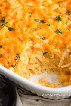 a casserole dish with cheese and parsley on top