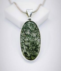 A beautiful handmade creation of Moss Agate Stone Pendant with Solid Sterling 925 Silver. We make our jewelry with fine quality of workmanship and high quality semi precious stones. This Beautiful Moss Agate Stone is from . This is a beautiful handmade creation. Moss Agate speeds up recovery from illness. It is anti-inflammatory, cleanses the circulatory and elimination systems, and boosts the immune system. It assists midwives by lessening pain and ensuring a good delivery. Moss Agate prevents Round Moss Agate Jewelry With Natural Stones, Handmade Silver Moss Agate Jewelry, Spiritual Silver Moss Agate Jewelry, Silver Moss Agate Jewelry Gift, Silver Moss Agate Jewelry As A Gift, Spiritual Agate Jewelry With Polished Finish, Silver Moss Agate Jewelry For Gift, Jade Oval Pendant With Natural Stones, Silver Moss Agate Healing Jewelry