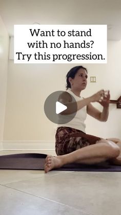 a woman sitting on a yoga mat with her hands together in the air, and text overlay that reads want to stand with no hands? try this progression