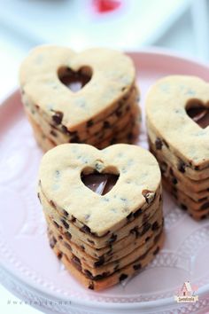 chocolate chip heart cookies on a pink plate with hearts cut out of the top one