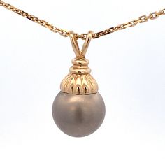 "Gray Tahitian Round Pearl Drop Pendant Set in 14k Yound Gold Vintage     Chain is not included Metal Content: 14k Yellow Gold Pearl: Tahitian Pearl Size: 12.5mm Pendant Measurements Length:  15/16\" (24mm) Width:  1/2\" (12.5mm) Bail opening: 1.5mm x 4mm Weight:  2.7 Grams Stamps: 14k JCM Condition: New Each piece is thoroughly examined and refinished as needed by our professional jewelers, tested to guarantee metal content,  graded by our in-house GIA (Gemological Institute of America) Graduat Elegant Yellow Gold Tahitian Pearl Jewelry, Classic Gold Jewelry With Tahitian Pearl, Pearl Drop Pendant, Vintage Chain, Tahitian Pearls, Drop Pendant, Pearl Size, Gold Pearl, Pearl Drop