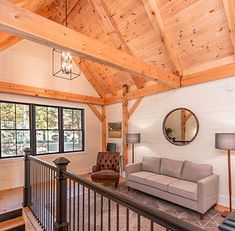 a living room filled with furniture and a wooden ceiling