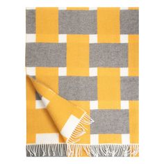 a yellow and grey checkered blanket with fringes