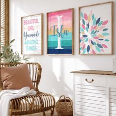 three framed pictures hang on the wall above a wicker chair in a white room