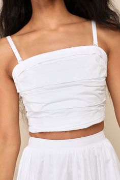 From errands to casual dates and everywhere in between, we love the Lulus Daytime Perfection White Cotton Pleated Cropped Sleeveless Top! Lightweight woven poplin shapes adjustable spaghetti straps (with detachable hooks for a convertible, strapless look) that support a sleeveless bodice with an irregular textured of folded pleats. Straight neckline and cropped hem give this top and ultra-wearable design! Smocked panel at back for fit. Pair with the matching skirt for a complete look! Fit: This Chic Cotton Camisole With Built-in Bra, Spring Sleeveless Tube Top With Built-in Bra, Summer Tube Top With Built-in Bra And Tank Straps, White Ruched Sleeveless Tube Top, Casual Strapless Camisole With Built-in Bra, Summer Cotton Tops With Built-in Bra, Cropped Cotton Tank Top With Tie Straps, Spring Cotton Vest Crop Top, Sleeveless Cotton Crop Top With Tie Straps