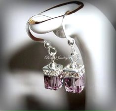 Light Amethyst Austrian crystals measure 6mm that are complimented with a crystal squaredelle to complete this lovely set of earrings. They hang from silver ear wires. You may choose different colors from the drop-down menu. These are perfect to gift to your bridesmaids, best friend, daughter and many more.... Check my shop for matching bracelets!  Click here to return to my shop's homepage: https://www.etsy.com/shop/beadedjewelryforyou?ref=simple-shop-header-name&listing_id=604235185 Mothers Birthstone Bracelet, Drop Earrings Wedding, Beautiful Baubles, Bridal Party Jewelry, Diamond Life, Wedding Earrings Drop, June Birthstone Jewelry, Bride Earrings, Mother Of Bride