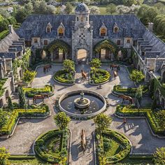 this is an aerial view of a mansion with gardens and horses in the front yard