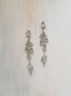 Sparkling Silver Dangle Cluster Earrings, Formal Sparkling Long Drop Chandelier Earrings, Long Drop Crystal Earrings With Sparkling Stones, Sparkling Silver Long Drop Crystal Earrings, Silver Sparkling Long Drop Crystal Earrings, Glamorous Silver Long Drop Earrings, Sparkling Dangle Linear Earrings For Evening, Sparkling Silver Dangle Linear Earrings, Sparkling Long Drop Crystal Earrings