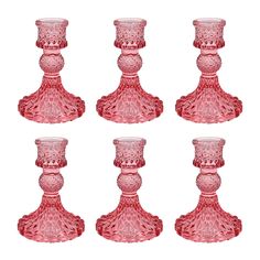 six pink glass candlesticks are lined up