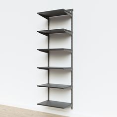 an empty shelf against a white wall