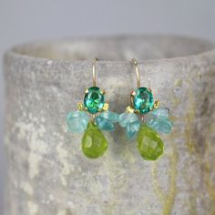 Incredibly beautiful soft and feminine bee earrings are made of bezel set blue zircon in copper with a cluster of apatite gemstones for the wings. Delicate green glass drop dangles down gently. This unique design is timeless, so you can enjoy it for years and years to come and pass it on. Bee earrings smartly finishes off your look for the elegant everyday or any special occasion. The hook is made of gold filled. The earring's hook can be made with sterling silver or solid gold incase of allergy Fusion Green Earrings With Natural Stones, Green Natural Stones Fusion Earrings, Green Fusion Earrings With Natural Stones, Green Natural Stone Fusion Earrings, Bohemian Green Earrings With Gemstone Accents, Handmade Green Briolette Earrings, Small Bees, Earrings Summer, Bee Earrings