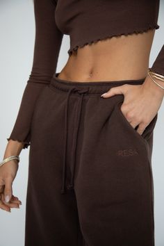 Elevate your comfort game with our Bodhi Sweatpants. Made with a drawstring waist for the perfect fit, experience optimal relaxation in these cozy sweatpants. Perfect for lounging at home or a casual day out. Upgrade your wardrobe with this must-have piece. Drawstring waist sweatpant with two front and one back pocket 100% Cotton Machine wash cold, tumble dry on low heat Model A: Paige is wearing a size XS Model A Measurements: Height: 5'8, Bust: 32B, Waist: 24", Hips: 34" Model B: Anyssa is wea Relaxed Style Sweatpants With Elastic Waistband, Relaxed Sweatpants With Elastic Waistband, Relaxed Sweatpants With Drawstring For Fall, Brown Athleisure Pants For Fall, Athleisure Brown Pants For Fall, Brown Cotton Lounge Pants, Brown Sweatpants With Elastic Waistband For Fall, Brown Cotton Pants For Loungewear, Brown Lounge Pants With Ribbed Waistband