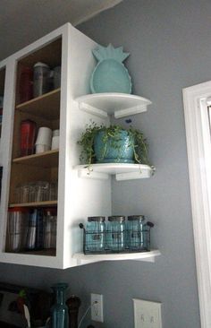 the shelves in the kitchen are filled with pots and pans on top of them