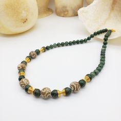 This jewelry combines genuine green jade beads and carved jade beading to create a complex look. We added gold plated spiral beads in between the beads. We use a high-quality 18K gold plating for a long-lasting finish. The beaded necklace is 21 inches long with a toggle bar closure.  This jewelry will ship with an information card. For centuries jade (jadeite and nephrite) has been highly prized throughout Asia for its unique qualities. In ancient China, jade was treasured above all other materials for its translucent beauty and exceptional hardness as well as for its spiritual and medical attributes.  Museum Reproductions These high-quality pieces are part of our regular line, once available only to museums, now available direct to you! Our authorized jewelry is created under license from Spiritual Gold Jade Beaded Necklaces, Spiritual Gold Jade Beaded Necklace, Gold Aventurine Beaded Jewelry, Traditional Green Jade Beaded Necklaces, Traditional Green Jade Beaded Necklace, Jade Beaded Necklaces With Spacer Beads For Gift, Handmade Gold Jade Beaded Necklaces, Gold Aventurine Beaded Necklaces, Gold Jade Gemstone Beaded Necklaces