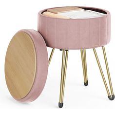 a pink stool with gold legs and a magazine holder