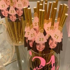 there is a vase full of gold straws with pictures on them and the number twenty one