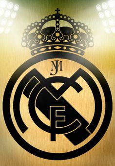 the real madrid logo is shown on a gold metal surface with lights in the background