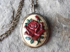 Beautiful cameo locket!!!  The cameo is a gorgeous flawless rose with a single bud, each cameo is individually hand painted, each an original!!!  The silver plated or bronze locket is victorian style with beautiful etching on both the front and back, 2" long, the last two photos are for sizing not color.  It can hold two photos and/or a treasured keepsake!!! Pass down from generation to generation!!! The bronze locket comes with a matching 24" rolo link chain (lead and nickel free), and the silv Rose Red Roses Jewelry For Weddings, Rose Red Jewelry With Roses For Wedding, Rose Red Wedding Jewelry With Roses, Rose Red Roses Wedding Jewelry, Red Cameo Jewelry For Wedding, Vintage Rose-colored Jewelry For Weddings, Vintage Rose Necklace For Wedding, Vintage Rose Wedding Jewelry, Vintage Rose Jewelry For Wedding