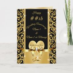 wedding anniversary card with gold ribbon and two hearts on black background, in front of a vase filled with flowers