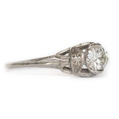 VIEW A VIDEO OF THIS RING https://youtu.be/Qmahlguln0E Description: Beautiful and simply elegant! This piece is a 1930s Art Deco style Platinum engagement ring featuring a GIA Certified 0.48ct Round Brilliant cut center diamond! Gorgeous designs on filigree encompass this ring with floral-like and sharp definition of shapes. They are bold and create immense texture to be seen without having to look closely. It is in amazing condition and truly timeless! This is a true antique piece, and we are h Round Brilliant Engagement Ring, 1930 Art, Platinum Engagement Ring, 1930s Art, Platinum Engagement Rings, 1930s Art Deco, Gorgeous Design, Deco Style, Art Deco Fashion