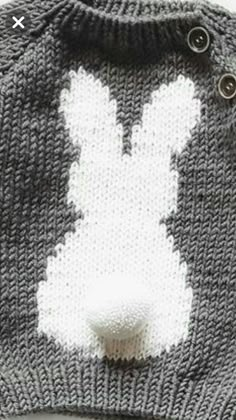 a knitted bunny hat with buttons on it