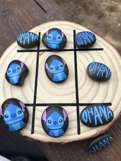 some rocks that have been painted to look like avatars on them and the words ohana spelled in blue