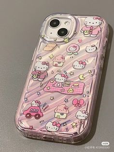 an iphone case with hello kitty and other cartoon characters on the back, sitting on a table