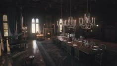 a large dining room with chandeliers hanging from the ceiling and long tables set for eight