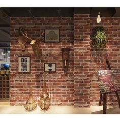 a brick wall with various items on display in front of it, including vases and deer heads