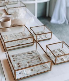 there are many glass trays on the table