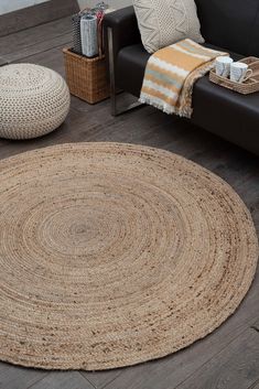 a living room with a couch and rug on the floor