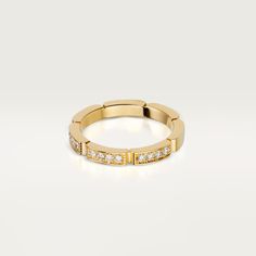 a yellow gold ring with white diamonds