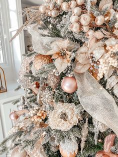 a christmas tree decorated with gold and silver ornaments