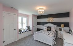 a bedroom with black and white stripes on the wall, pink walls and gray carpet