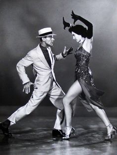 a man and woman are dancing on stage