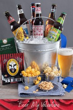 a bucket full of beer and snacks on a table