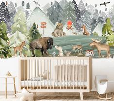 a baby's room with an animal mural on the wall and a crib