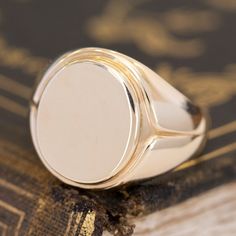 This vintage signet ring from the famed house Tiffany & Co. is big, bold, and gold - three of our favorite things here at JbyG. The 14kt gold is such a warm and buttery tone, and when worn, the ring feels like armor on the finger! The top of the ring is blank and ready to be engraved with a message or image of your choosing - or leave her blank and let your daily life leave its mark! 14kt Yellow Gold Size 9.75 & fully resizable Please see qualitative report for more information. Classic Domed Signet Ring Hallmarked, Classic Hallmarked Domed Signet Ring, Classic Domed Hallmarked Signet Ring, Timeless Domed Signet Ring With Polished Finish, Domed Signet Ring With Polished Finish For Gift, Classic Rose Gold Signet Ring Stamped 14k, Classic Hallmarked Signet Ring For Collectors, Classic Hallmarked Signet Ring Collectible, Anniversary Hallmarked Domed Signet Ring