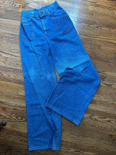 This pair of vintage h.i.s. Brand bellbottom jeans have a zipper with unique button closure.  The pockets have rays coming out with orange topstitching.  There is wear and fading as shown in pictures.  Waist-26 inches Hips-37 inches Rise-11.5 inches Inseam-32 inches Waistband-2 inches wide Belt loops-1.5 inches Thigh-20 inches Knee-21 inches Bell-23 inches To see more of our authentic 70's vintage clothing inventory please visit our store at ChoiceRecycling.  We add new items every week. Vintage Washed Wide Leg Pants, Retro Denim Flare Jeans With Pockets, Retro Full-length Light Wash Flare Jeans, Vintage Wide Leg Washed Pants, Faded Full-length Flare Jeans With Pockets, Faded Full Length Flare Jeans With Pockets, Faded Flare Jeans With Pockets, Faded Flare Jeans With Pockets Full Length, Vintage High-rise Washed Pants