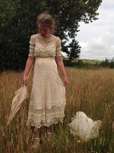 "A very beautiful tulle lace dress with a lovely tiny floral pattern, and lace ruffles it has a cream color This dress has a bit stretch and will a fit waist 70 cm 27.5\" bust 88 cm 34.5\" total length of the dress: 145 cm 57\" This dress has many discolorations and repairs. I saw several tiny holes, and there is brown underarm discoloration (picture 8) The dress is very beautiful because f the wonderful floral lace, the lace ruffles, the embroidery work and it's shape... My model is wearing a s Regency Style Cream Dress With Ruffles, Victorian Beige Dress With Ruffles, Beige Victorian Wedding Dress With Ruffles, Beige Ruffled Vintage Dress For Wedding, Beige Fitted Victorian Dress, Fitted Victorian Dress With Ruffles, Fitted Lace Dress With Ruffles For Garden Party, Fitted Lace Dress With Delicate Lace For Garden Party, Fitted Delicate Lace Dress For Garden Party